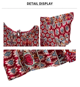 Détail de la robe bohème rouge montrant le col à lacets et l'imprimé cachemire complexe