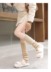 Winter wool knitted leg warmers and cozy faux fur slippers in beige and camel tones