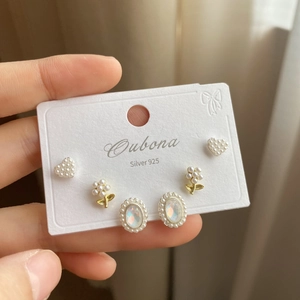 Detailed shot of S925 silver earring set with heart pearls and opal stone studs