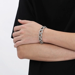Close-up of industrial style interconnected chunky silver chain bracelet on wrist