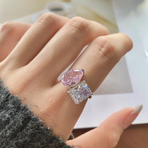 Elegant silver Toi et Moi ring featuring pink pear and white square cut stones on hand