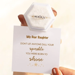 Star-shaped silver ring in a velvet box with a motivational gift card for daughter