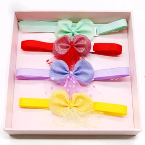Set of four colorful bow hair accessories in mint, red, purple and yellow for girls