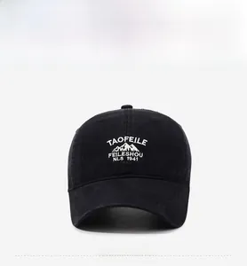 Detailed close-up of white 3D embroidery on black vintage washed cotton baseball cap