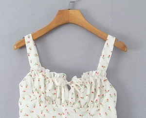 Close-up of floral camisole with red roses, ruffle trim and front bow detail