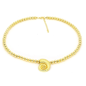Macro detail of golden bead necklace with a textured conch shell pendant and lobster clasp