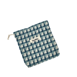 Blue and white checkered woven drawstring storage bag with premium textured fabric finish