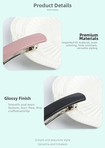 Detail view of pink and black glossy spring hair clips made of smooth PS material