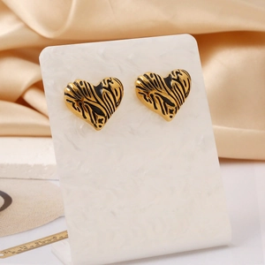 18K gold plated stainless steel heart earrings with black zebra pattern on silk background