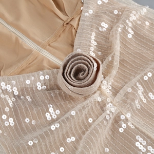 Detail of champagne sequin mesh fabric with handmade 3D rose and invisible zipper