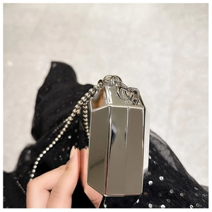 Detail of silver geometric hard shell clutch bag with metallic bead chain strap