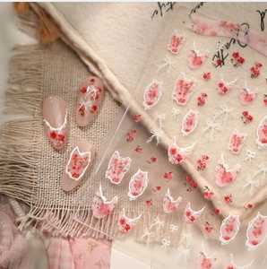 French style nail stickers with dried rose patterns and white bow accents on nude nails