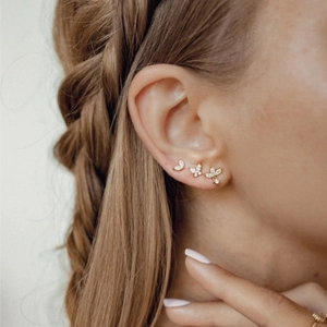 Gold butterfly and marquise stud earring set with white zircons on female model