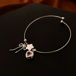 Silver bow heart zircon bracelet featuring pink heart gemstone and silver flower charms