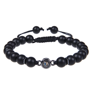 Detail of matte black stone bead bracelet with a central metal projection bead
