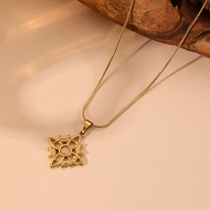 Detail of gold crescent moon and Celtic knot pendant with white opal on snake chain