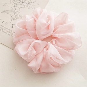 Detailed close-up of a large pink chiffon scrunchie showing the soft pleated texture