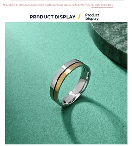 Macro shot of two-tone stainless steel ring with a central groove on a textured background