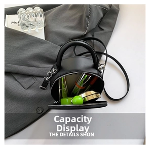 Top view of black leather semi-circle handbag interior showing makeup storage capacity