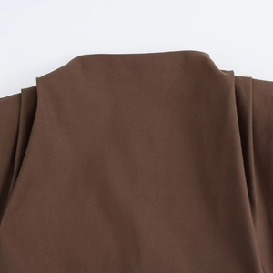 Close-up of coffee brown sleeveless top showing neckline and pleated shoulder texture