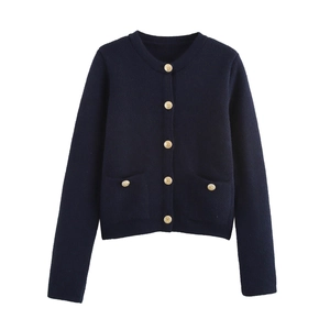 Detailed view of dark blue knit cardigan with golden embossed buttons and dual front pockets