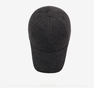 Top view detail of dark gray knit baseball cap showing warm textured fabric for winter