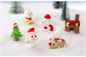Miniature resin Christmas bunny set with Santa hats and winter sled scenery decor