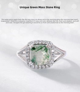 Macro detail of moss agate ring with halo zircons and cushion cut green gemstone