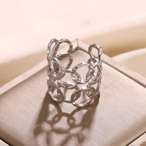 Detailed close-up of a silver hollow-out geometric link ring displayed on a jewelry box
