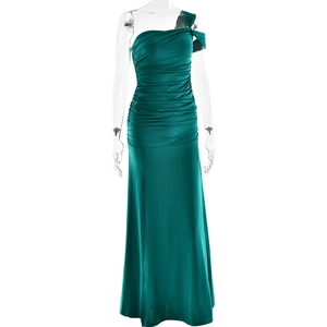 Detailed close-up of green one-shoulder dress showing ruched fabric and side split detail