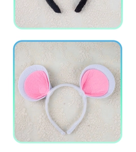 Detail of plush white mouse ears headband with pink inner lining on lace background