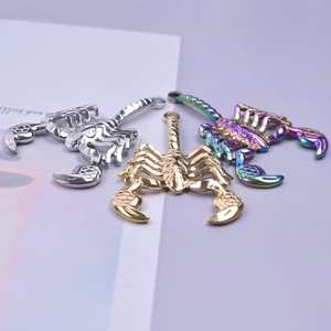 Macro view of stainless steel scorpion pendants in silver, gold, and rainbow finishes