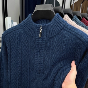 Detailed view of dark blue cable knit texture and metal half-zip on men's winter sweater