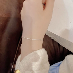 Minimalist S925 sterling silver twist chain bracelet worn on wrist for an elegant look