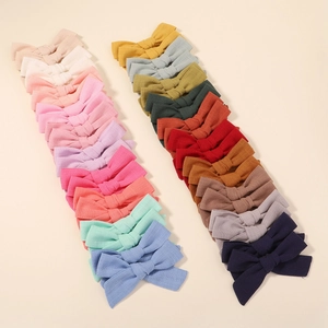Collection of colorful fabric bow hair clips for girls in various candy colors