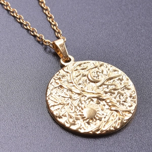 Close-up of 18K gold stainless steel sun and tree of life pendant showing fine details