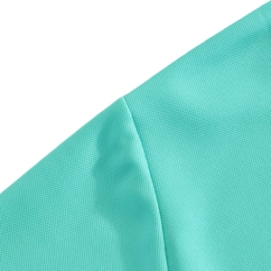Detailed macro view of mint green pique polo fabric showing breathable mesh texture