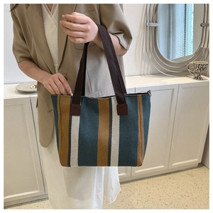 Close-up of green and yellow striped canvas tote bag showing thick fabric texture