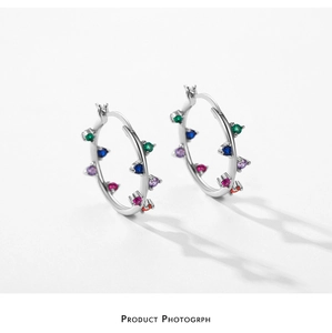Macro detail of S925 silver hoop earrings featuring multi-color round-cut zircon stones