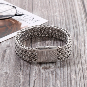 Detailed view of silver titanium steel mesh bracelet with magnetic square clasp on wood