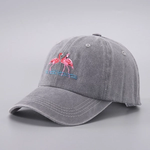 Close-up of embroidered red flamingos on gray washed denim cotton baseball cap