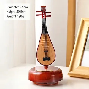 Lute music box with wooden finish, 20.5cm height, 9.5cm diameter on a brown base