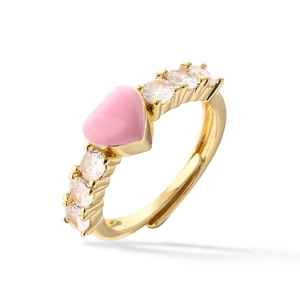 Macro shot of gold open ring with pink enamel heart and clear cubic zirconia side stones