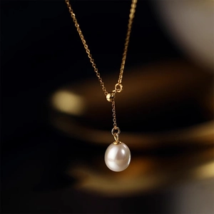 Elegant gold Y-chain necklace featuring a luminous white rice-shaped freshwater pearl pendant