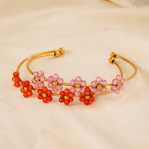Golden stainless steel bangles featuring handcrafted zircon bead flowers in pink and orange