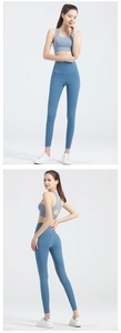 Detail of high waisted fog blue yoga leggings with side pockets and back cutout sports bra
