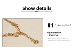 Detail of gold snake chain bracelet with lobster clasp and a small heart pendant