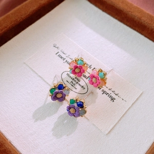 Sweet crystal flower stud earrings with pink and purple petals on a silver needle base