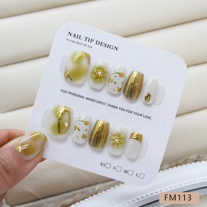 Handmade press-on nails with green marble texture, floral patterns and gold relief details