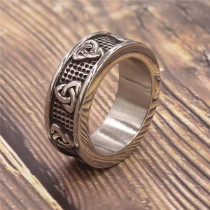 Macro detail of the vintage Celtic knot relief and mesh texture on the stainless steel ring